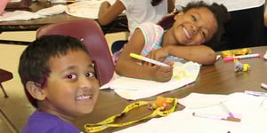 Boy and girl coloring on t-shirts